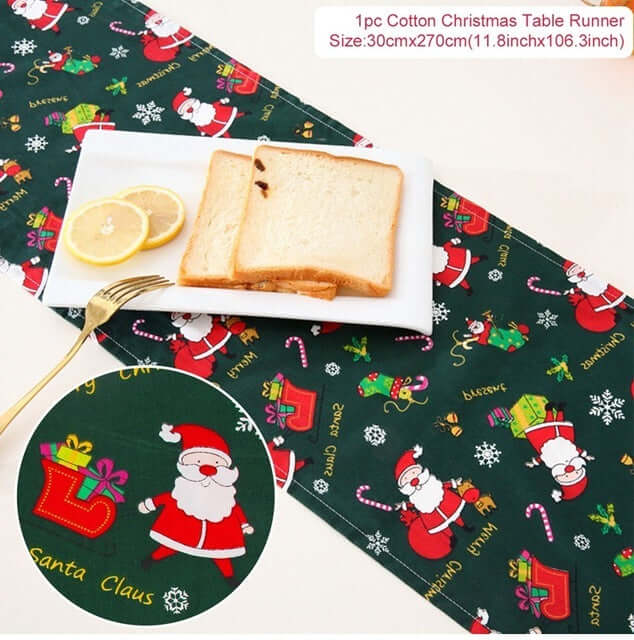 Cotton Christmas table runner with Santa Claus design on dark green, bread and lemons on plate.