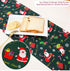Cotton Christmas table runner with Santa Claus design on dark green, bread and lemons on plate.