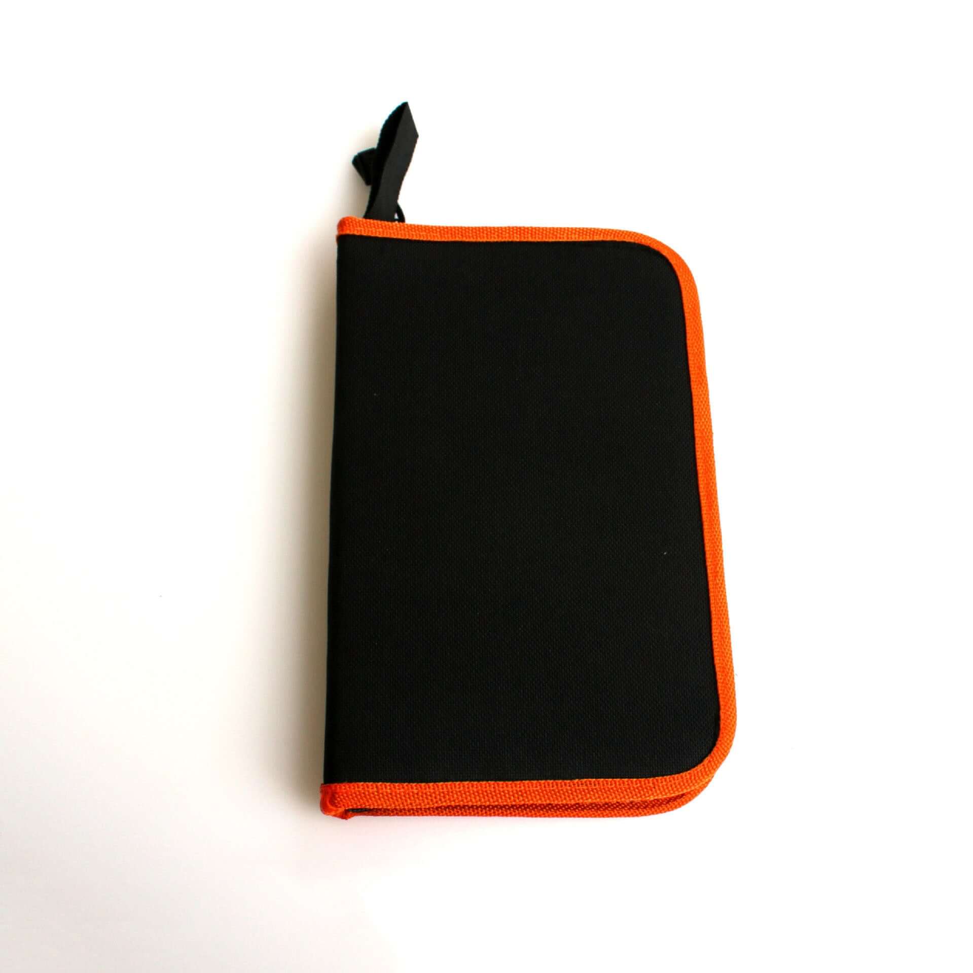 Black kitchen utensil storage case with orange trim on white background