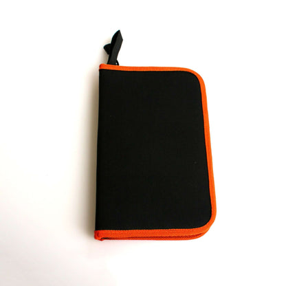Black kitchen utensil storage case with orange trim on white background