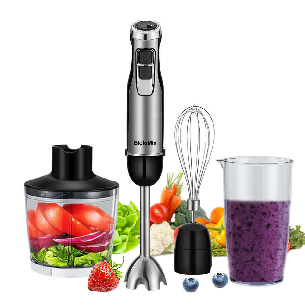 Stainless steel hand blender set with whisk, chopper, mixing cup, and fresh fruits and vegetables.