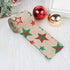 Burlap Christmas ribbon with red and green glitter stars, festive ornaments beside it