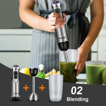 Handheld immersion blender mixing green smoothie in kitchen with accessories and ingredients