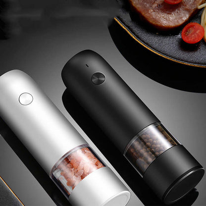 Electric salt and pepper grinders in sleek black and white design on kitchen counter