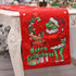 Red Christmas table runner featuring cartoon characters, festive gifts, and holiday decor