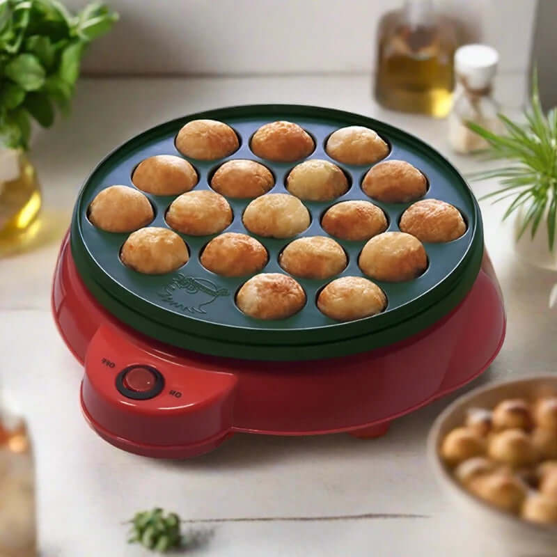 Electric takoyaki maker with golden brown takoyaki balls on a kitchen countertop