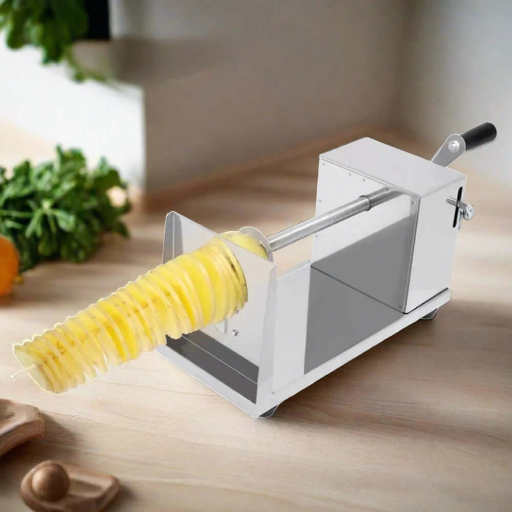 Stainless steel spiral potato slicer on kitchen countertop with spiral-cut potato