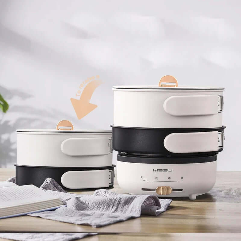 Stackable electric food steamer with white and black compartments on a kitchen counter