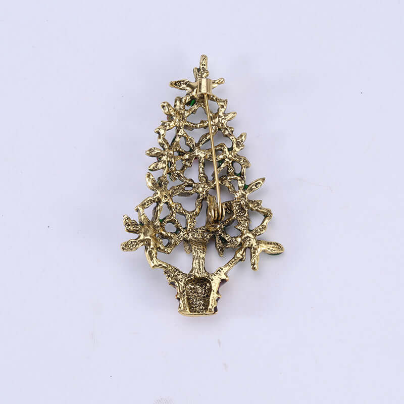 Gold tree-shaped decorative brooch with textured metal branches and safety pin clasp