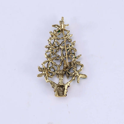 Gold tree-shaped decorative brooch with textured metal branches and safety pin clasp