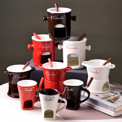 Assorted ceramic chocolate fondue pots and mugs with forks, red, white, and brown colors.