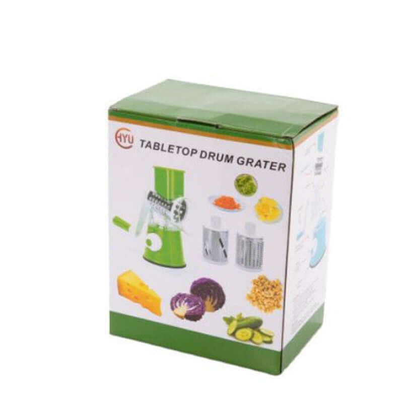 Box of green tabletop drum grater with interchangeable blades for cheese and vegetables.