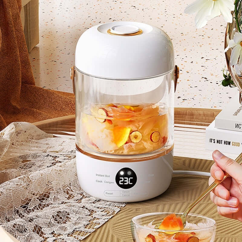 Electric glass kettle with digital display cooking fruit dessert in a modern kitchen setting