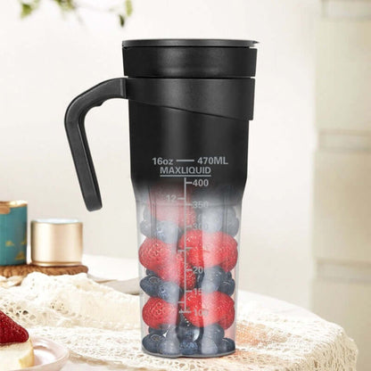 Portable kitchen blender cup filled with strawberries and blueberries on a table