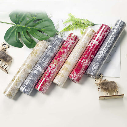 Assorted Christmas-themed kitchen drawer liners with festive snowflake patterns, flat lay.