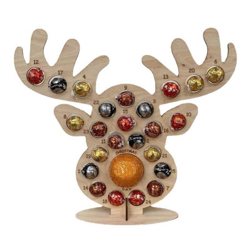 Wooden reindeer advent calendar holding assorted chocolate balls, festive kitchen decor