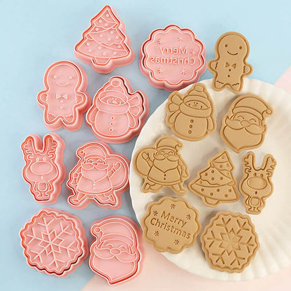 Christmas-themed cookie cutters and embossed cookies with Santa, snowman, tree, and reindeer designs