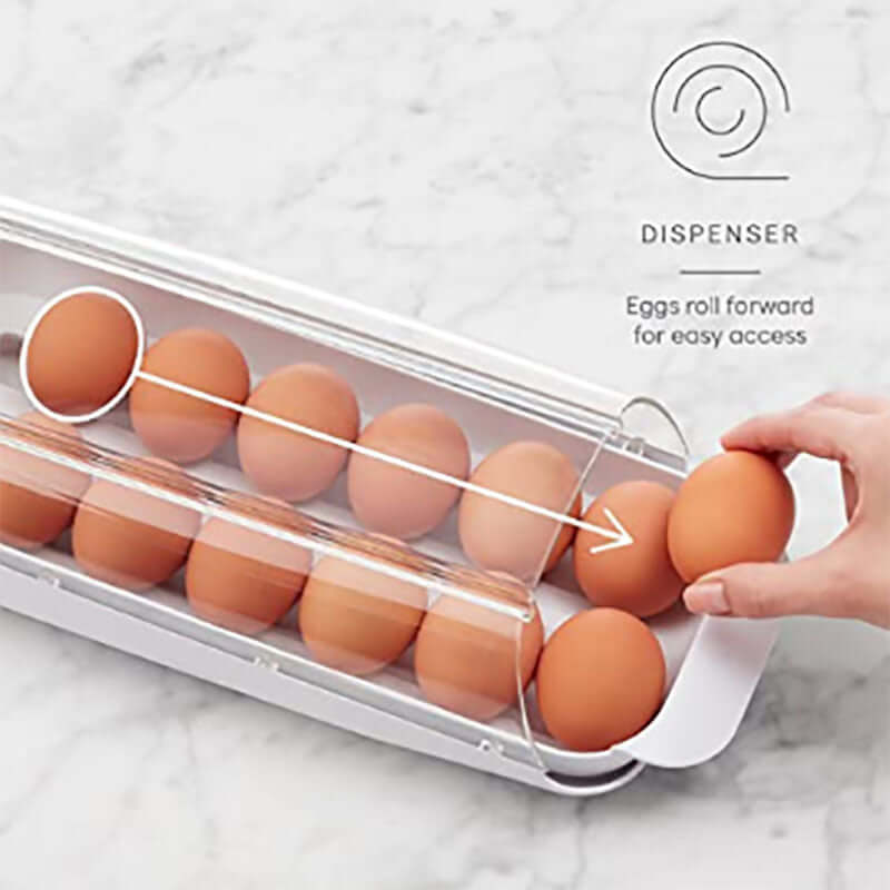 Egg dispenser kitchen accessory with eggs rolling forward for easy access on marble countertop