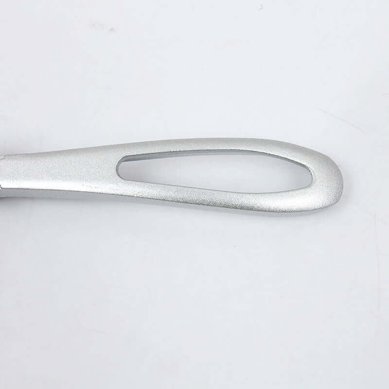 Metal kitchen utensil handle with ergonomic open-loop design on white background