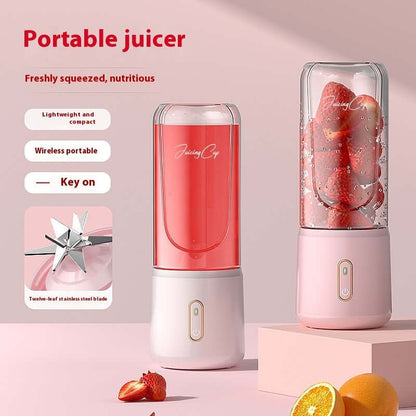 Pink portable juicer blender with strawberries and orange, wireless and compact kitchen accessory