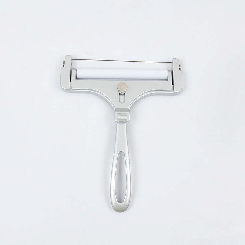 Stainless steel adjustable cheese slicer kitchen tool on white background