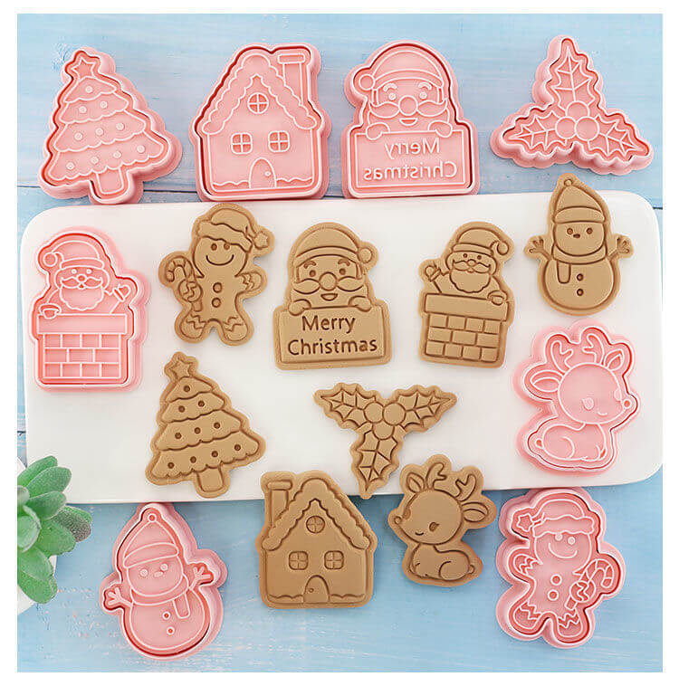 Christmas cookie cutters and cookies shaped like Santa, tree, reindeer, gingerbread man