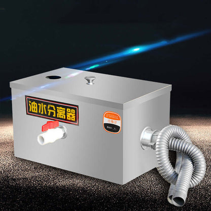 Stainless steel kitchen grease trap separator with valve and drainage hose on dark background