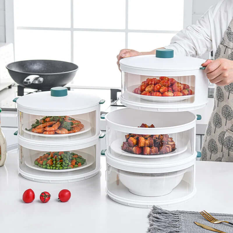 Stackable plastic food storage containers with clear lids on a kitchen counter, holding various dishes.