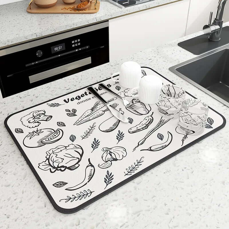 Vegetable print kitchen drying mat on countertop with cups, glasses, and knife