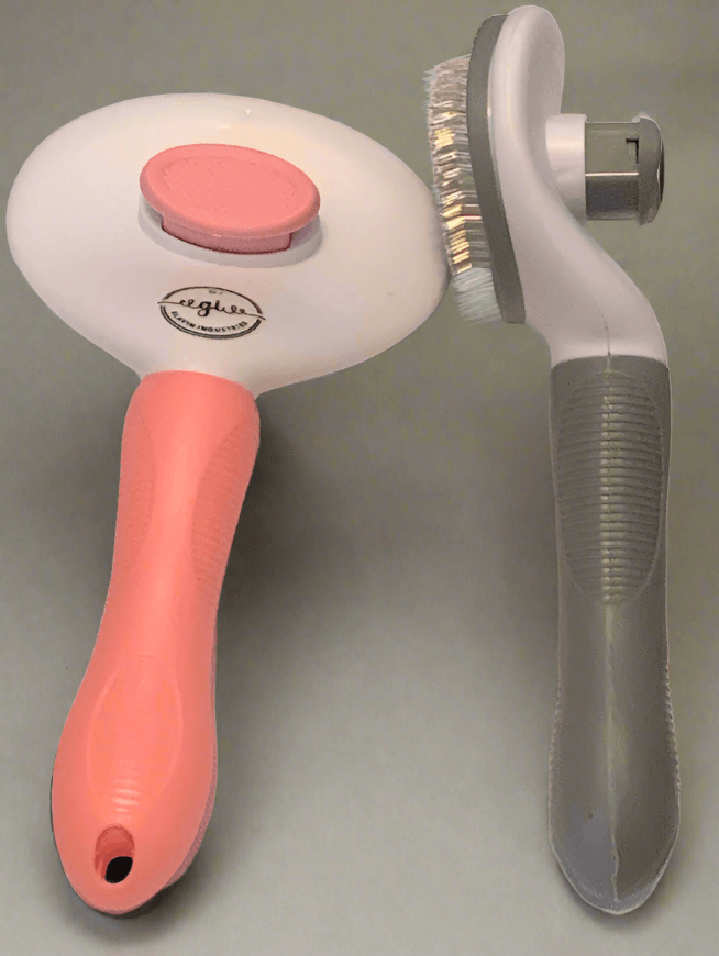 Dual-sided kitchen scrub brush with soft pink handle and gray ergonomic grip.
